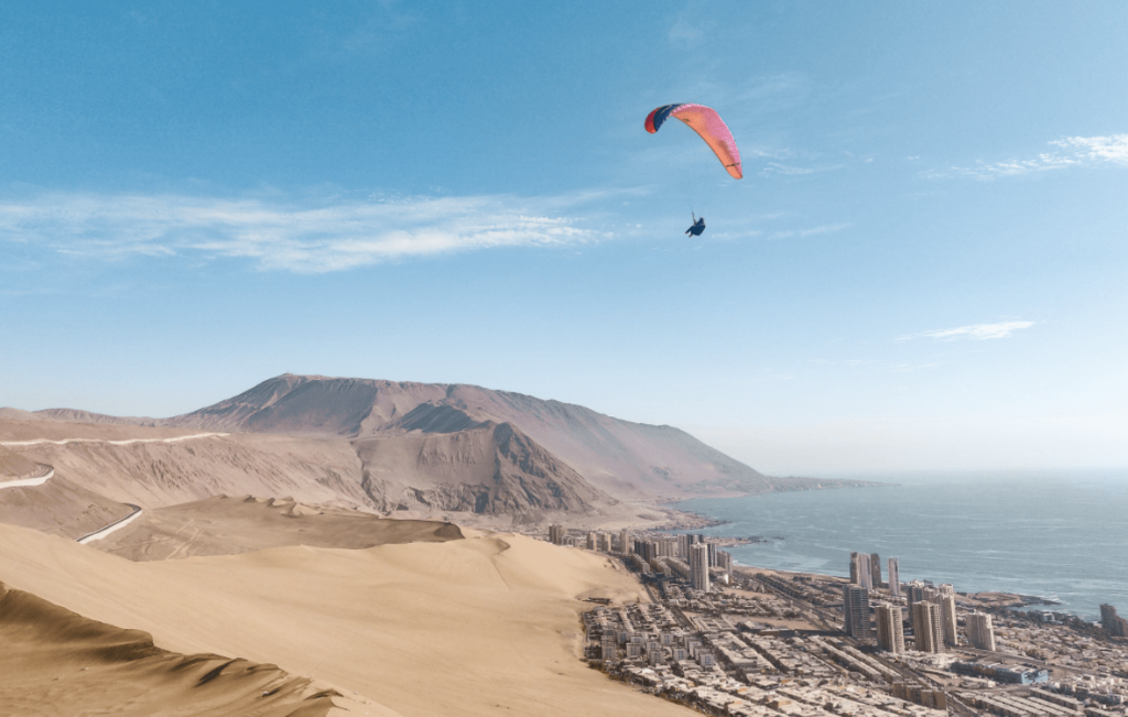 Paraglide above the coastal dune city of Iquique