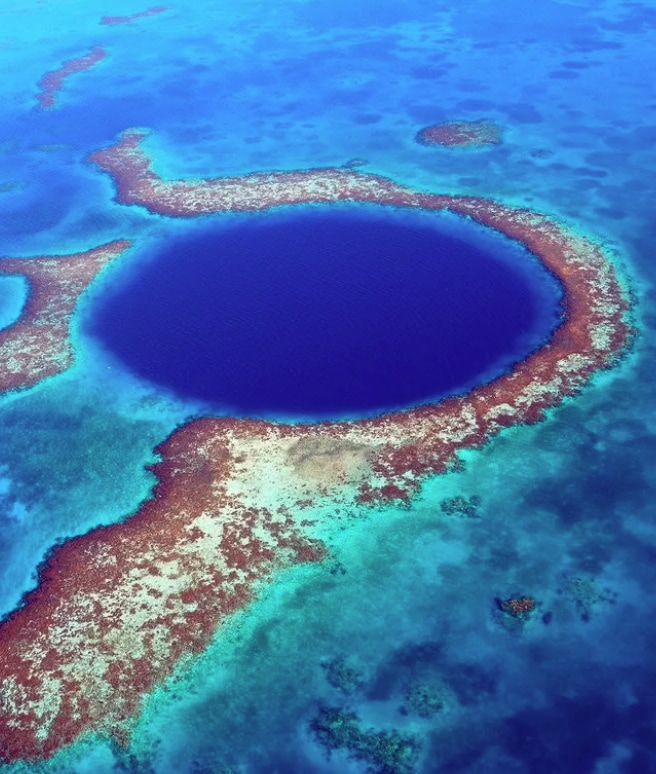 Fly over the famous Great Blue Hole... or dive in it!