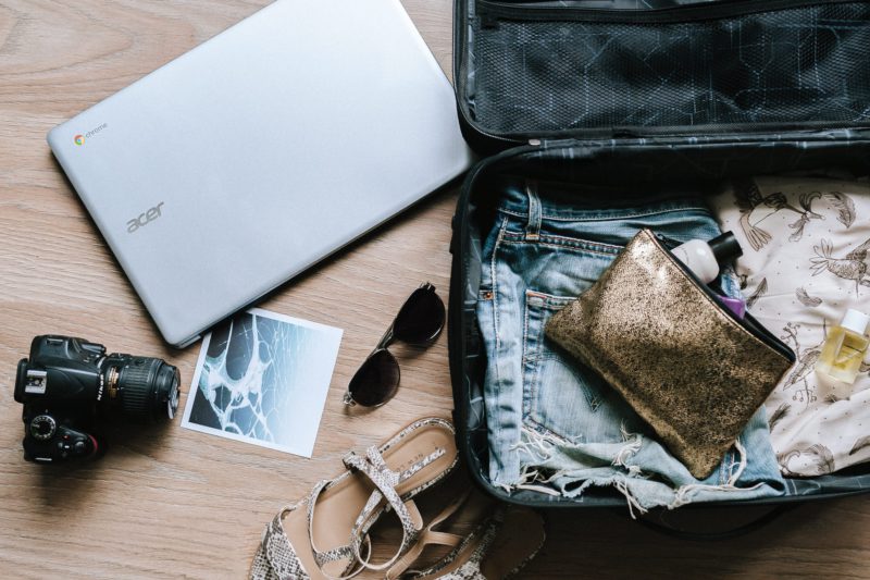 Image of an open suitcase showing travel essentials