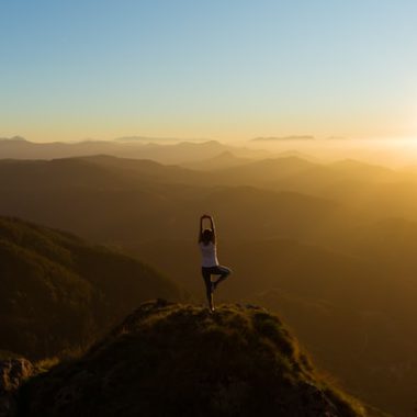 Woman on mountain in yoga pose
