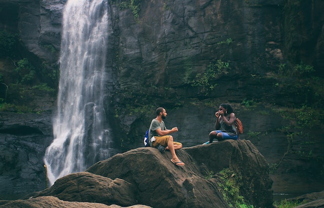 Two people at waterfall