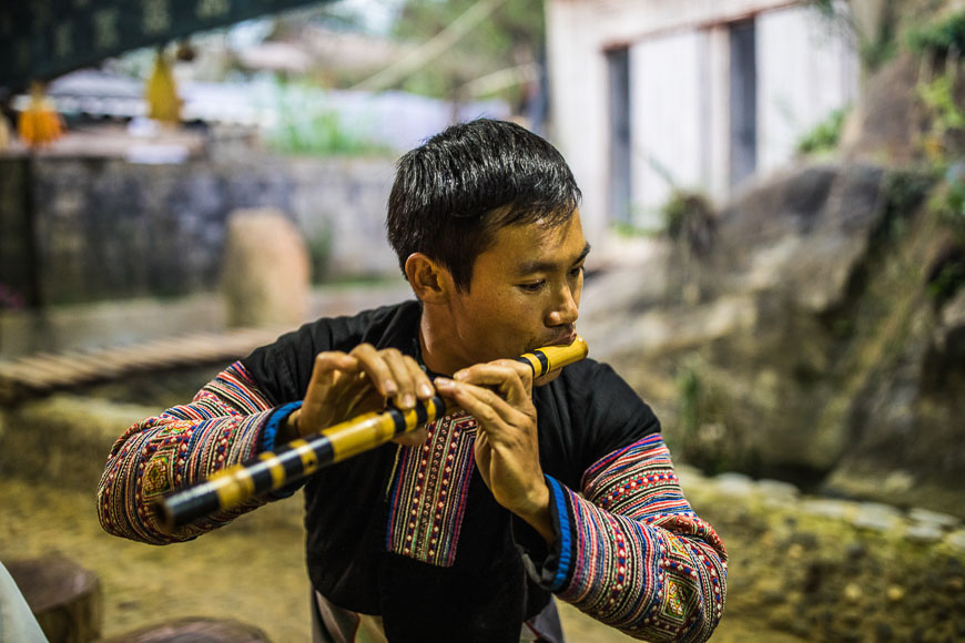 A local from Mai Chau, Thailand, playing a traditional musical instrument.