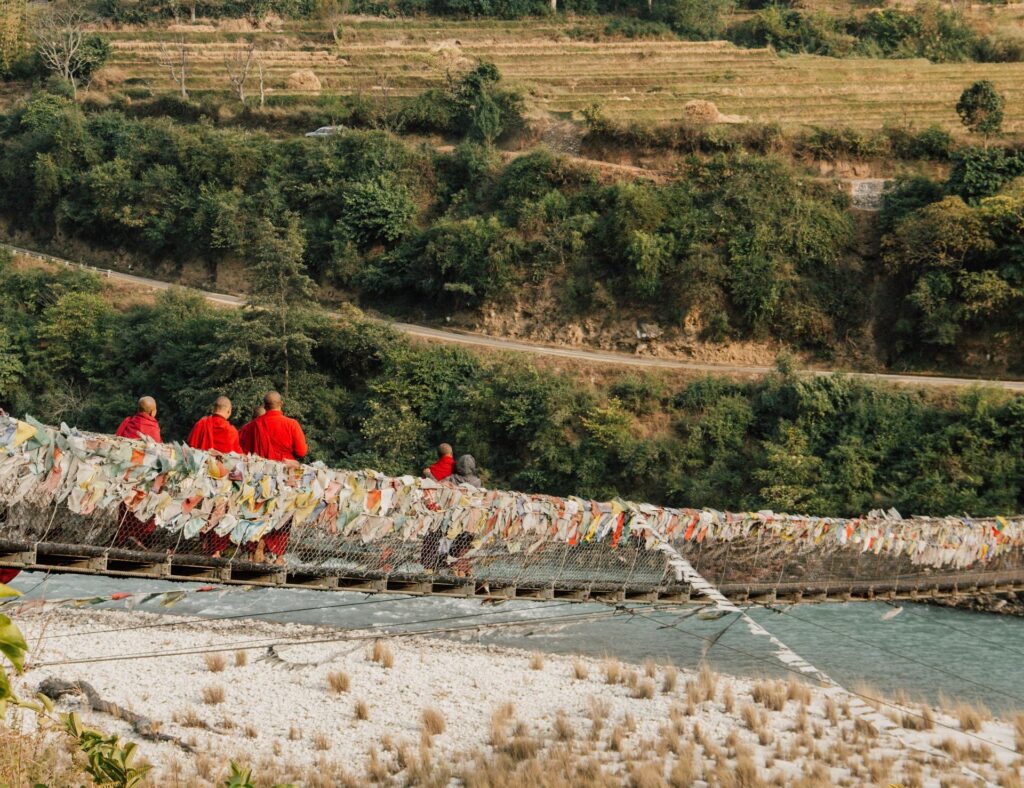 Monks on bridge in Bhutan